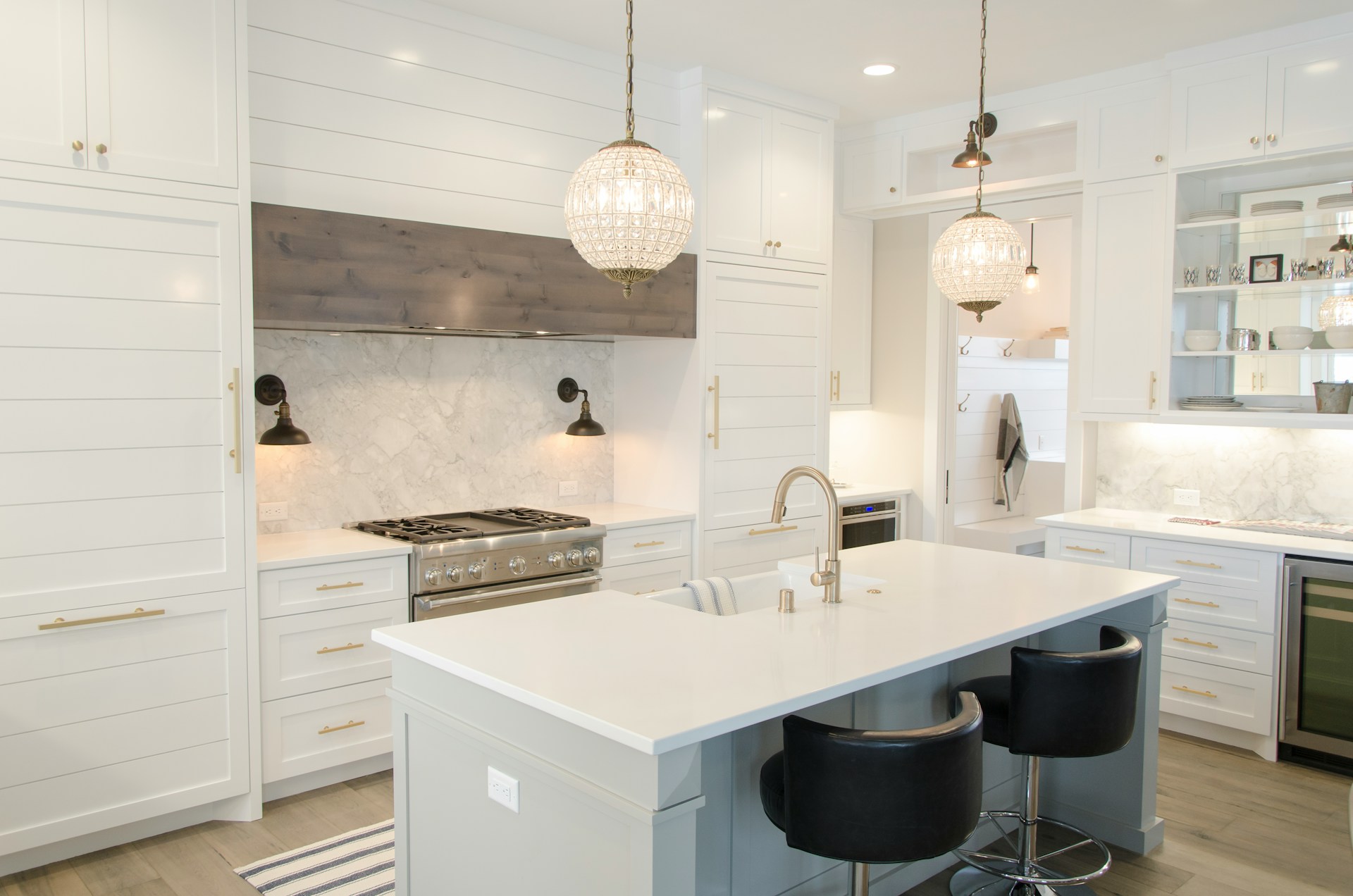 remodeled white kitchen with gold hardware