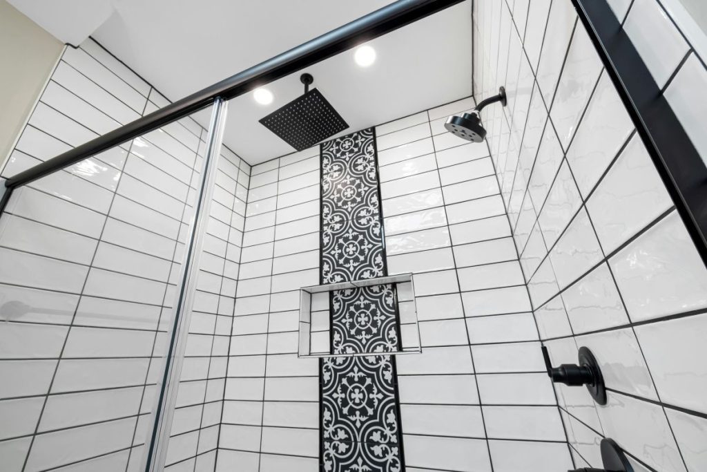 Newly remodeled black & white bathroom shower with rainfall showerhead