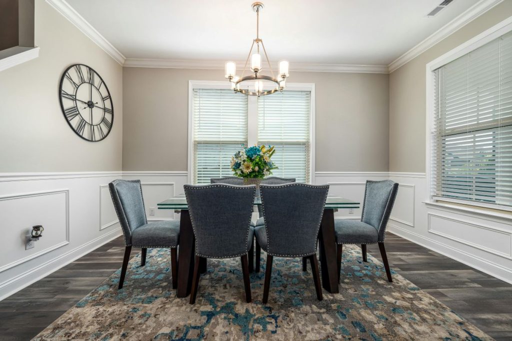Elegant dining room with classic white wainscotting on walls